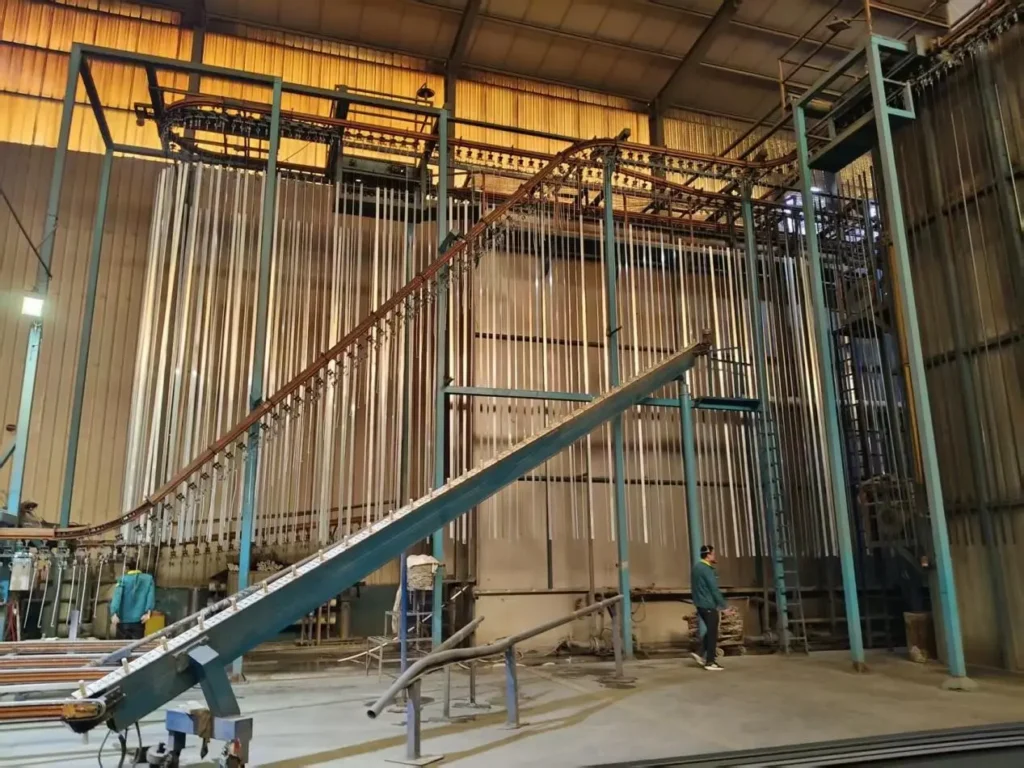 Precision manufacturing and stable quality control in aluminum extrusion facility by Yoverd Aluminium, showing large-scale hanging production line with hundreds of profiles for ultra-high dimensional accuracy, perfect straightness and consistent mechanical performance
