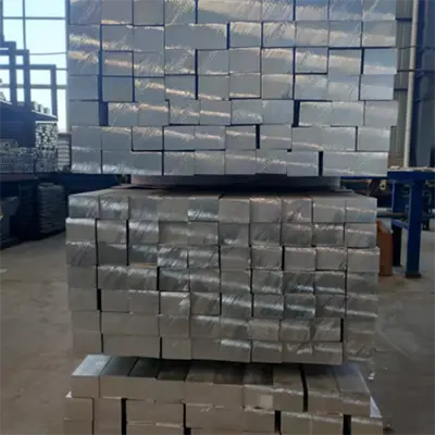Inventory of neatly stacked and wrapped solid square aluminum bars in warehouse by Yoverd Aluminium, perfect for structural, machining and industrial applications