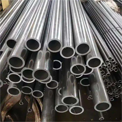 Large quantity of shiny custom aluminum round tube extrusions stacked in industrial warehouse, showcasing various diameters for global engineering projects by Yoverd Aluminium.