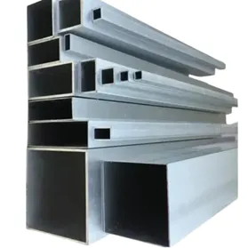 Side view of heavy-duty rectangular and square aluminum profiles stacked in multiple sizes, displaying uniform wall thickness and high-quality surface finish for structural applications. By Yoverd Aluminium.