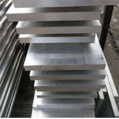 Neatly stacked silver CNC machined aluminum solid rectangular bars with smooth surface and precise dimensions, displayed in industrial setting for custom machining projects by Yoverd Aluminium.