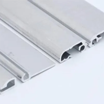 Close-up view of sleek silver grey aluminum decorative profiles showing detailed cross-sections and grooves, ideal for modern interior architectural applications in living spaces by Yoverd Aluminium.