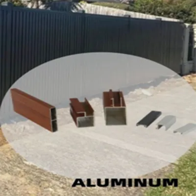Assortment of modern aluminum privacy screen railing profiles including wood-grain and silver finishes displayed outdoors beside a black fence with gravel ground for residential and commercial applications by Yoverd Aluminium.