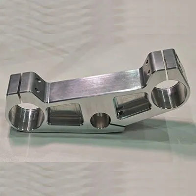 High precision CNC machined silver aluminum automotive bracket featuring multiple mounting holes and structural cutouts for lightweight vehicle and structural applications by Yoverd Aluminium.