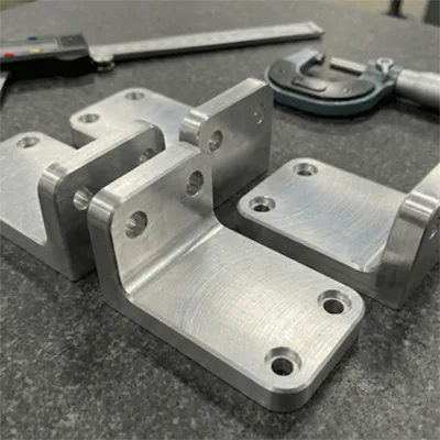 Set of high precision CNC machined aluminum automotive brackets displayed with precision measuring tools like calipers and micrometer, showcasing quality for lightweight vehicle and structural applications by Yoverd Aluminium.