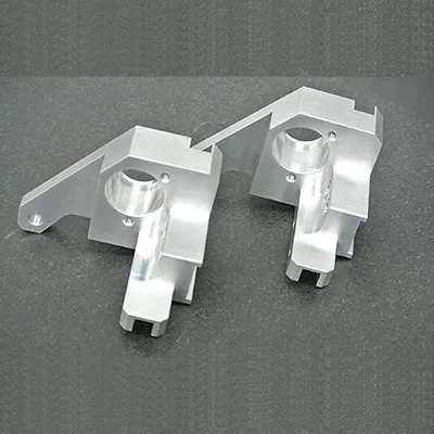 Pair of high precision CNC machined aluminum brackets with cylindrical bores and complex structural designs for lightweight vehicle and high-performance structural applications by Yoverd Aluminium.