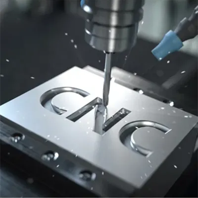 Close-up of high precision CNC milling machine cutting intricate letters into a shiny aluminum plate with flying metal chips and coolant by Yoverd Aluminium