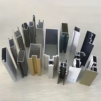 Various custom aluminum extrusion profiles with different cross-sectional designs and finishes arranged on a light surface by Yoverd Aluminium.