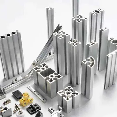 A collection of silver aluminum extrusion profiles featuring T-slot designs, along with various connectors, fasteners, and accessories arranged on a white background for industrial framing applications by Yoverd Aluminium.