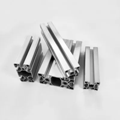 Collection of various sized heavy-duty aluminum structural profiles displaying different cross-section designs and slot configurations for industrial framing systems by Yoverd Aluminium.
